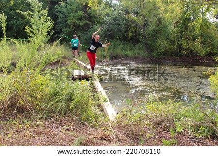 MUSKOGEE, OK - Sept. 13: Athletes run through zombie-infested forest and bog during the Castle Zombie Run at the Castle of Muskogee in Muskogee, OK on September 13, 2014.
