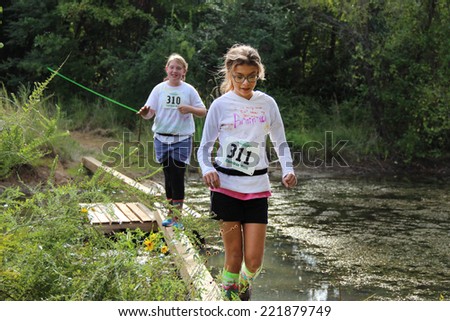 MUSKOGEE, OK - Sept. 13: Athletes run through zombie-infested forest and bog during the Castle Zombie Run at the Castle of Muskogee in Muskogee, OK on September 13, 2014.