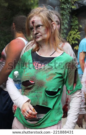 MUSKOGEE, OK - Sept. 13: A bloody female zombie waits for runners during the Castle Zombie Run at the Castle of Muskogee in Muskogee, OK on September 13, 2014.