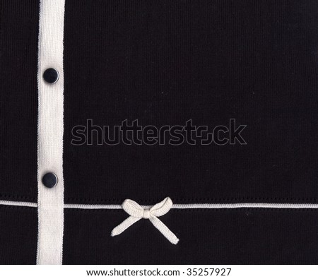 Detail of a black blouse with a bow and buttons for background