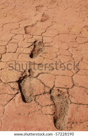 Dry ground with bare foot prints