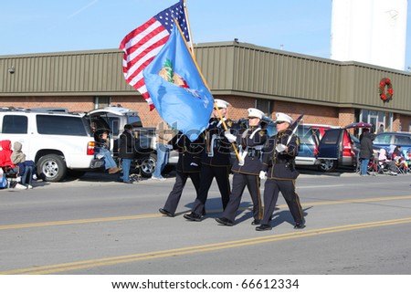 BROKEN ARROW, OK-DECEMBER 4: Broken Arrow Police members proudly carry American and Oklahoma flags to open Christmas Parade on December 4, 2010.