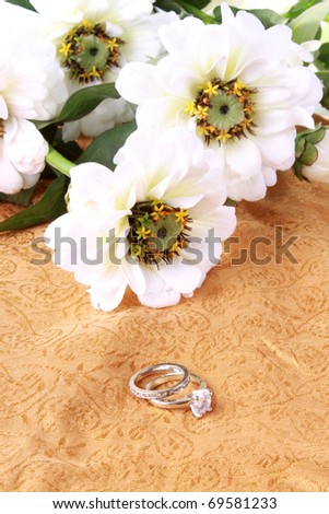 stock photo Wedding or engagement ring with white flowers