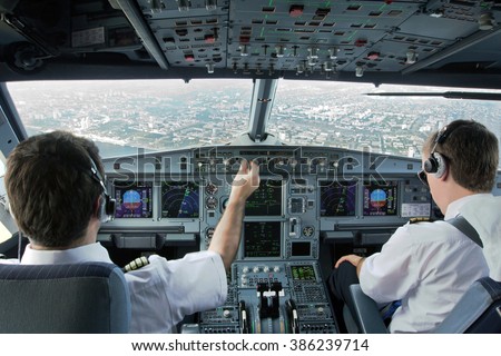 Flight Deck of modern plane.The pilots (cockpit crew) of aircraft prepares for landing at the airport.