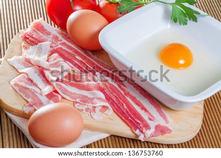 A delicious bacon and eggs on a wooden background