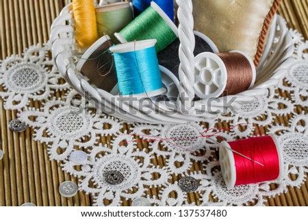 spools of thread on a wooden background