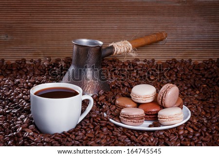 French macarons n the background of coffee beans