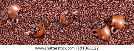 Panorama of roasted coffee beans and cups.