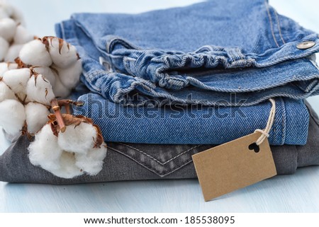 Stack of clothes with a sprig of cotton