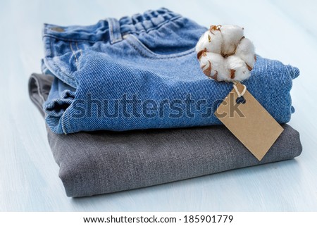 Stack of clothes with a sprig of cotton