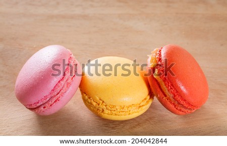 French macarons on a wooden background.