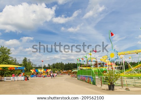ALSACE, FRANCE - JUNE 19, 2014; Tourists at the amusement park on Didi\'Land in Alsace, France. The Didi\'Land is a popular destination with many attractions on Alsace, France.