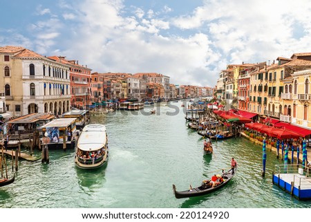 Venice, Italy  - 4 September, 2014: Boats and gondolas on the Grand Canal of Venice. Venice is the most popular tourist destination in Italy.