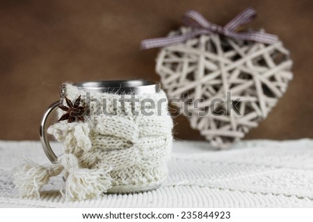 Cup in knitted cover
