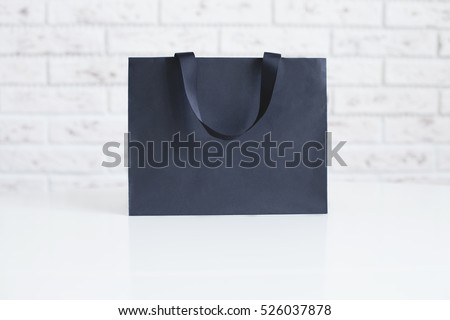 Mock-up of blank craft package, mockup of black paper shopping bag with handles on the white background