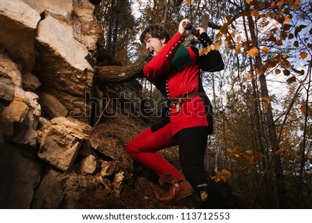 Medieval miner with a pick on the mountain