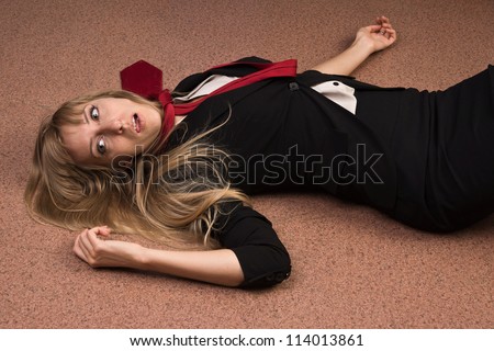 Crime scene imitation. Lifeless business woman lying on the floor