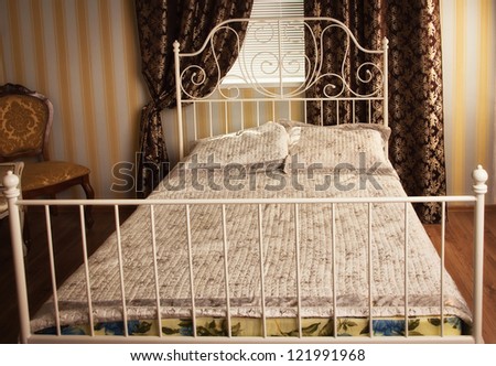 Old style bed in the elegant bedroom
