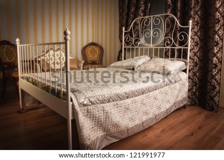 Old style bed in the elegant bedroom