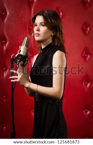 An elegant female singer with microphone