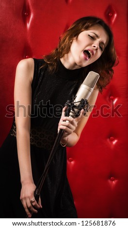 An elegant female singer with microphone