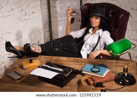 Retro detective girl sits at a table in the agency
