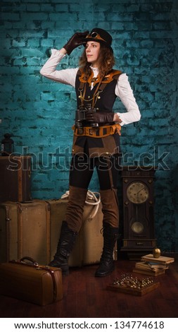 Steam punk girl with binocular in the hands