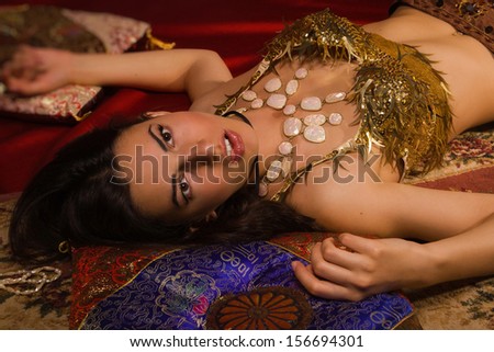 Crime scene imitation: lifeless woman in a traditional oriental costume lying on a floor