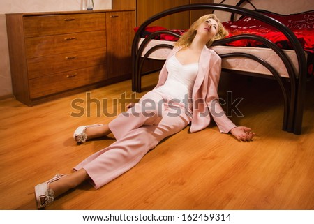 Crime scene simulation: unconscious business woman lying on the floor
