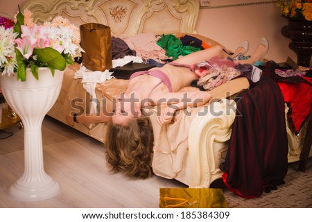 Crime scene simulation. Lifeless woman in a luxurious lingerie lying on the bed