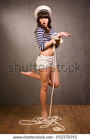 Beautiful navy pinup girl tangled in the rope