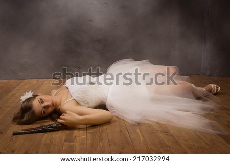 Bride corpse with pistol  in hand lying on the floor