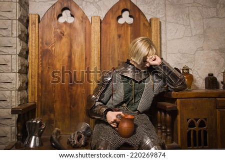Joan of Arc. Girl in a knight\'s armor in the interior of a medieval castle