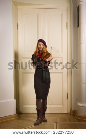woman painter with brushes in a luxurious interior