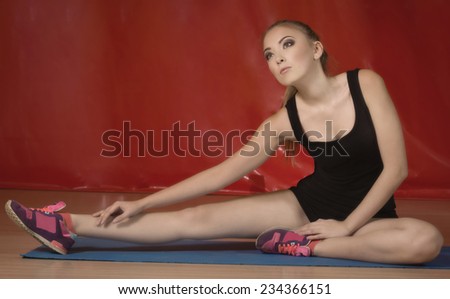 beautiful young girl stretching the muscles of her legs