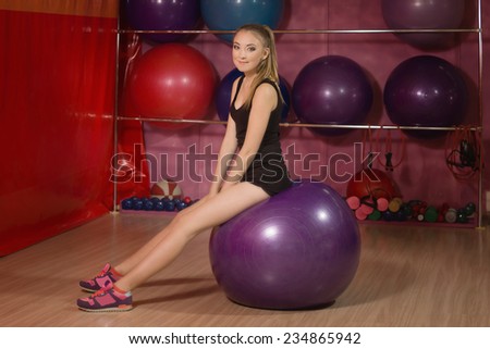 Young woman exercising with a fit ball