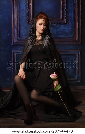 Very pretty woman vamp in the dark interior