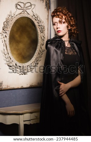 Very pretty woman vamp in the dark interior