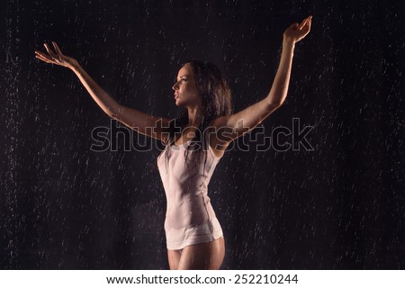 Sexy beautiful woman posing in white shirt under water