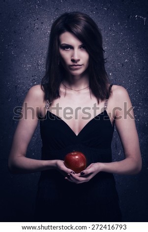 Asylum. Lonely mad woman with red apple. Low key.