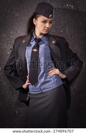 Russian woman police officer in uniform. Low key