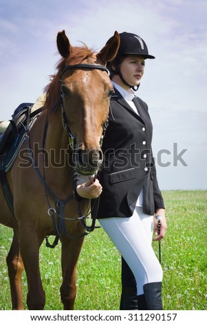 Beautiful young girl jockey with her horse dressing uniform competition