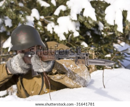 Soviet-Finnish war: Red Army soldier aims from a rifle. Focus on a rifle