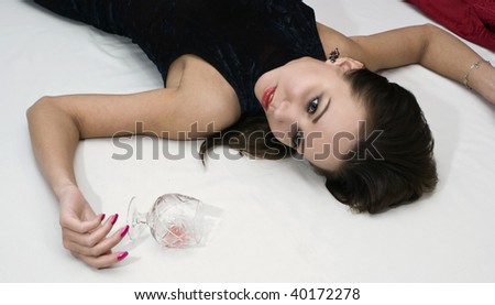 Young poisoned woman lying on the floor. Studio shot.