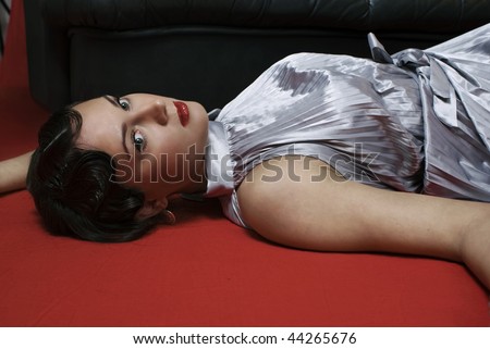 Dead woman lying on the floor. Studio shot in a retro style