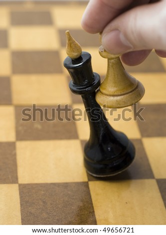 Queen chess pieces and a pawn on a chess board