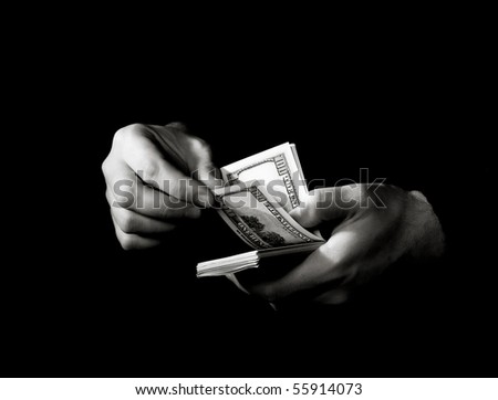 Hands with packs of dollars over black