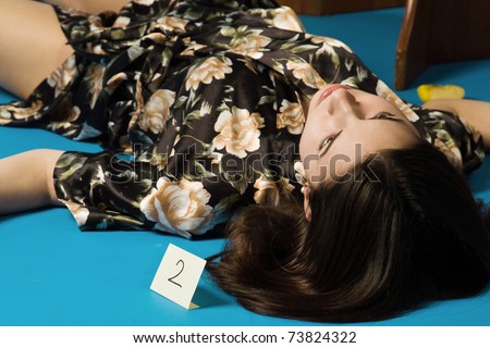 Lifeless brunette in a dressing gown lying on the floor