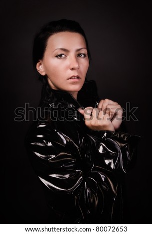 Portrait of the female spy brunette in latex