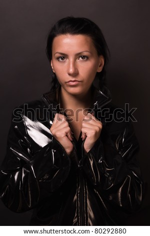 Portrait of the female spy brunette in latex